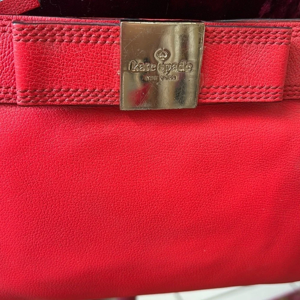 Kate Spade   Crossbody bag  leather orangeish red   bow on front chain strap det